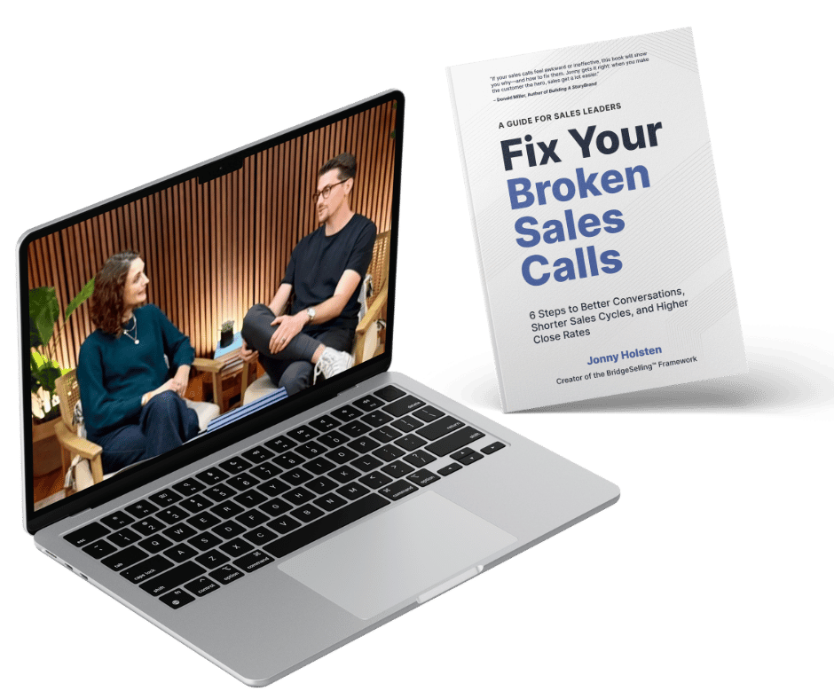 Open laptop showing two people in conversation on screen next to a tilted book titled 'Fix Your Broken Sales Calls' by Jonny Holsten.