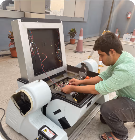 Man repairing robotic device.