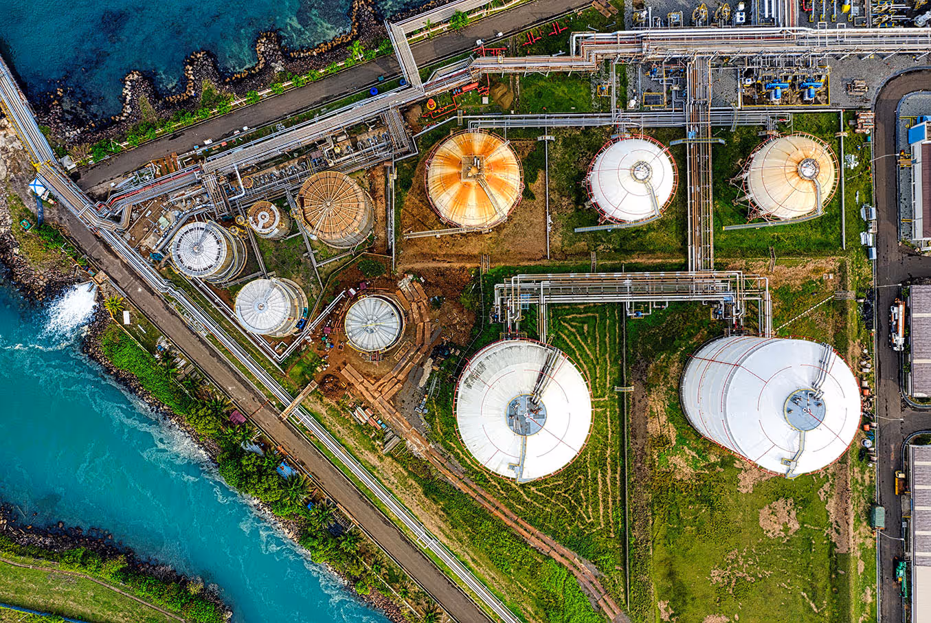 Oil tanks and refinery near ocean.