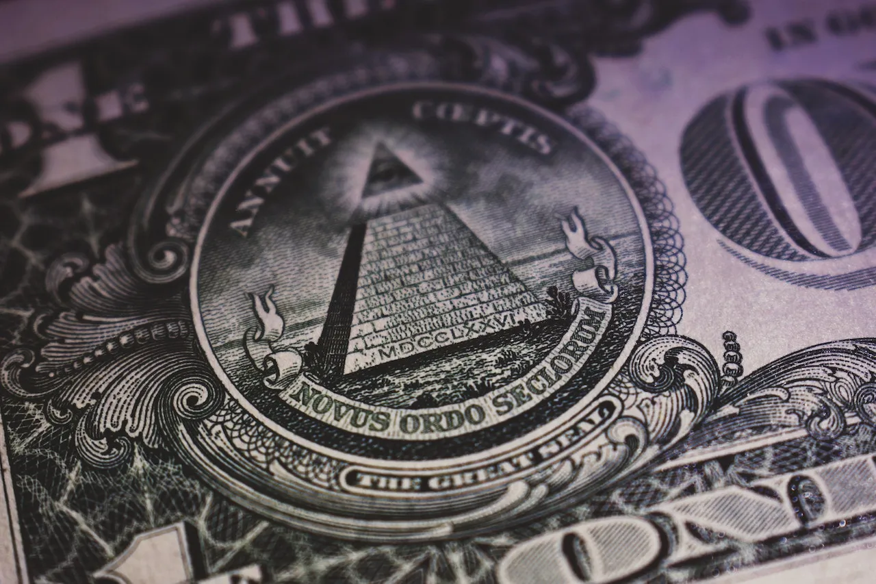 A closeup of the all seeing eye and pyramid on a U.S. dollar bill