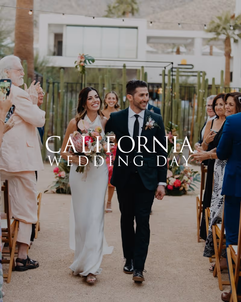 Bride and groom joyfully walking down the aisle surrounded by smiling guests at a stylish California wedding ceremony.