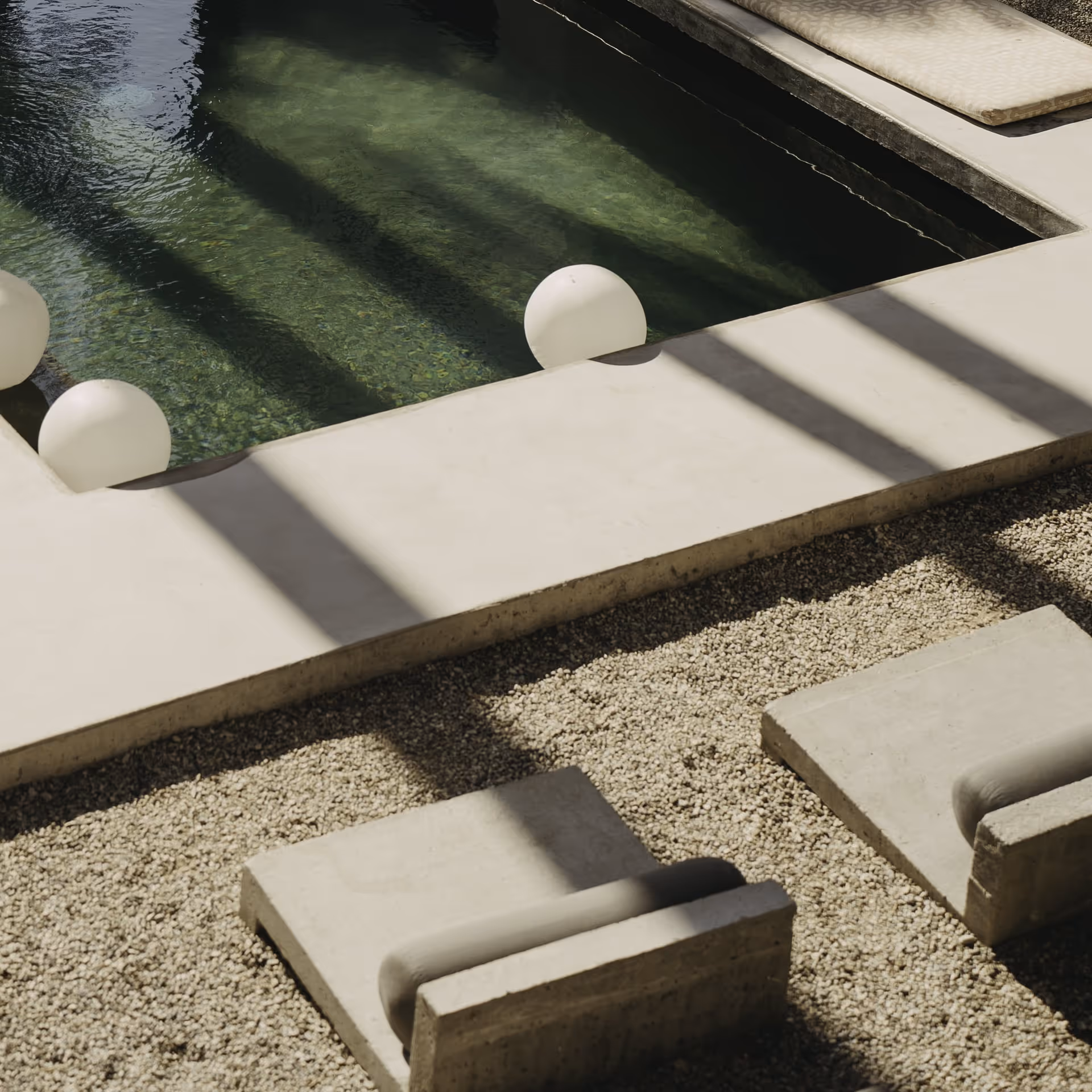 Minimalist concrete poolside lounge with shallow green water, floating white sphere lights, strong pergola shadows, pebble ground and low sunbeds — modern resort-style outdoor relaxation space.