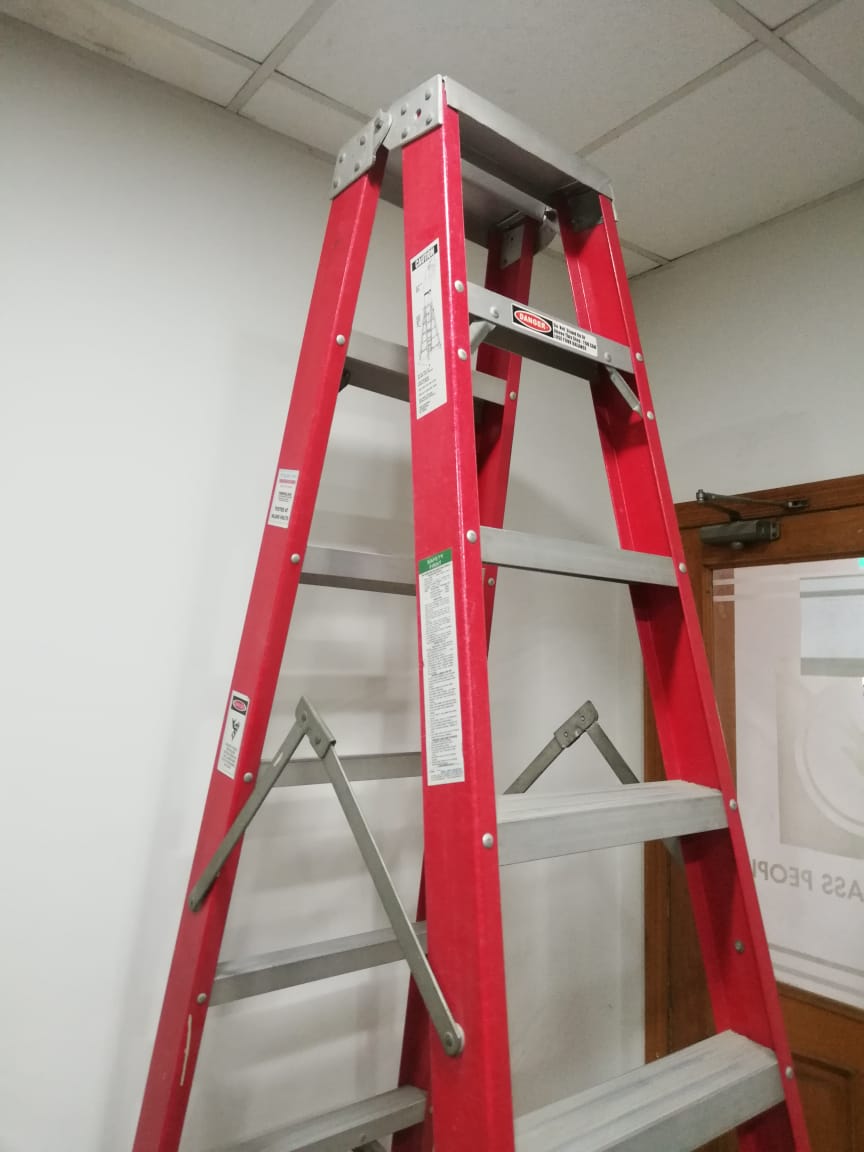 Fiberglass ladder with extended reach for utility maintenance