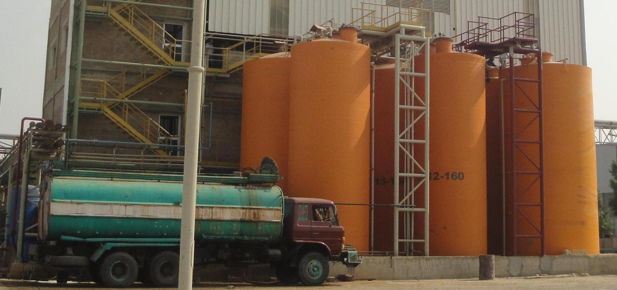 Vertical fiberglass tank for chemical processing plant