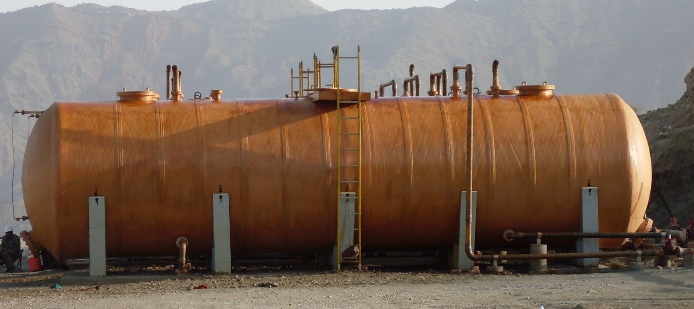 Fiberglass chemical storage tank installation at industrial site
