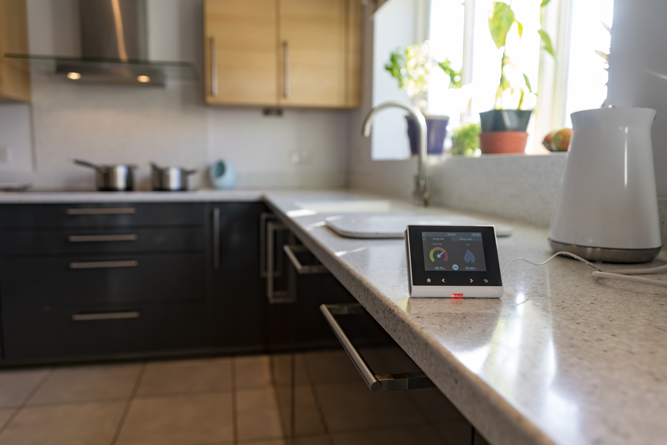 Live energy consumption and cost readings on household smart meter in kitchen