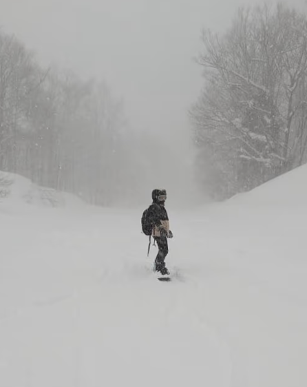 Photo of me snowboarding with a lot of snow.