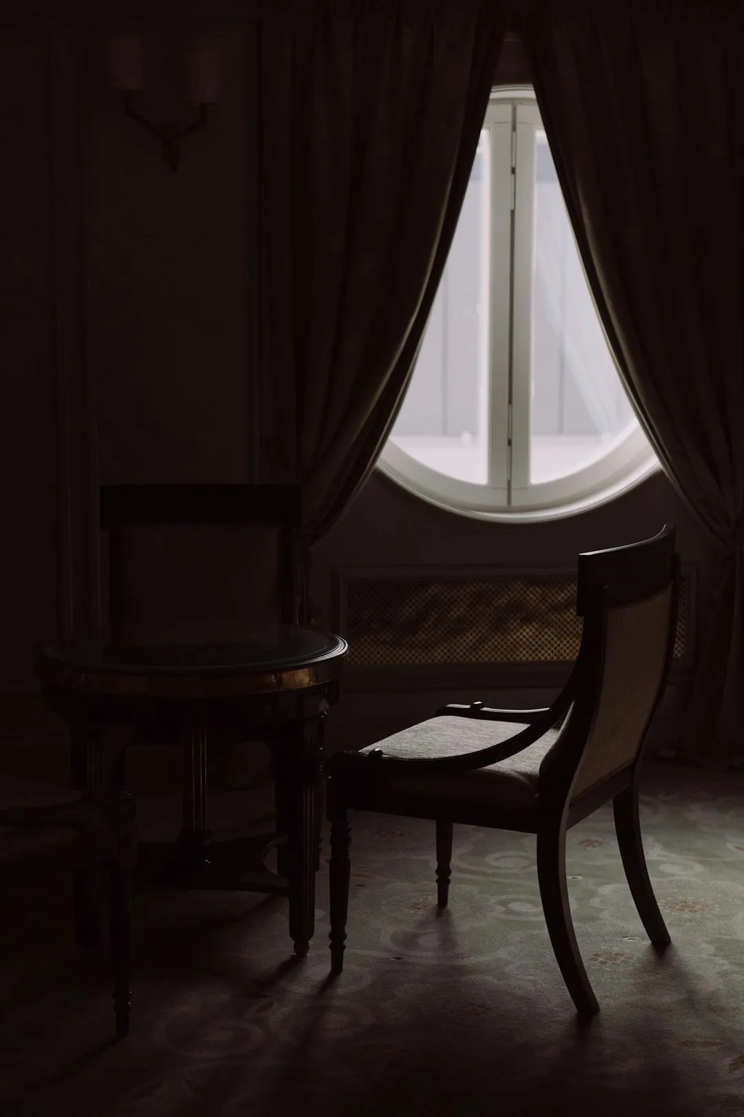 A luxury interior with curtains and a designer chair.