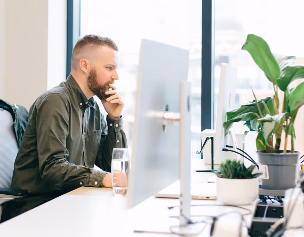 A photo of design team members smiling and laughing around a desk
