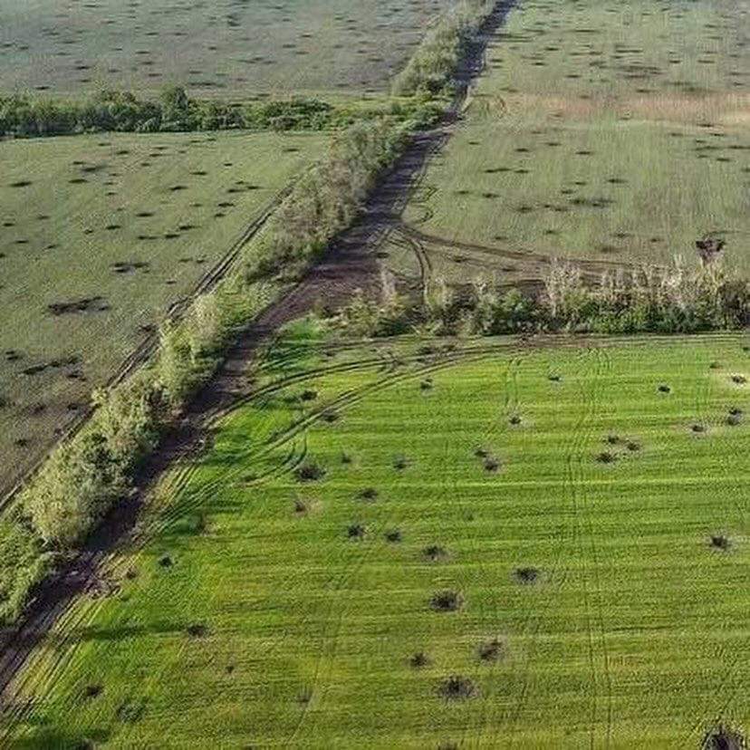Agricultural fields riddled with explosive ordnance damage in the Kharkiv region of Ukraine.