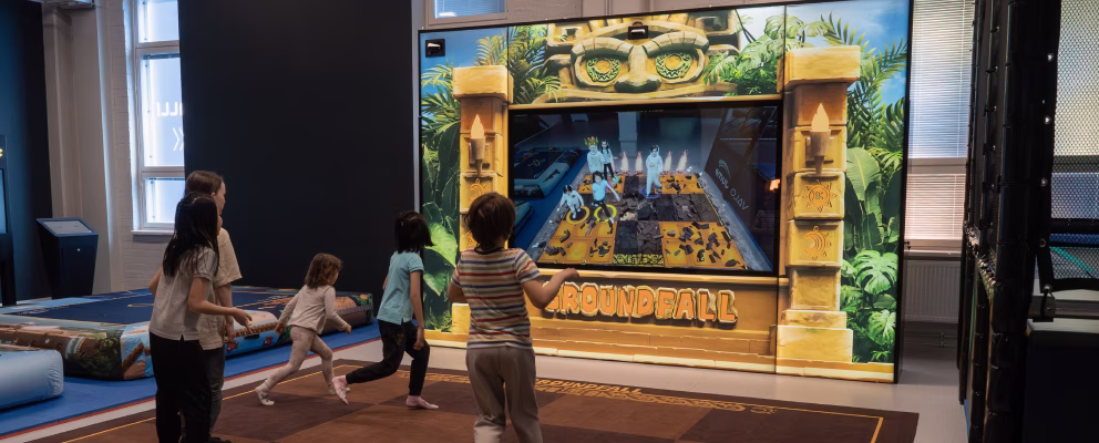 Five kids playing excitedly on Groundfall