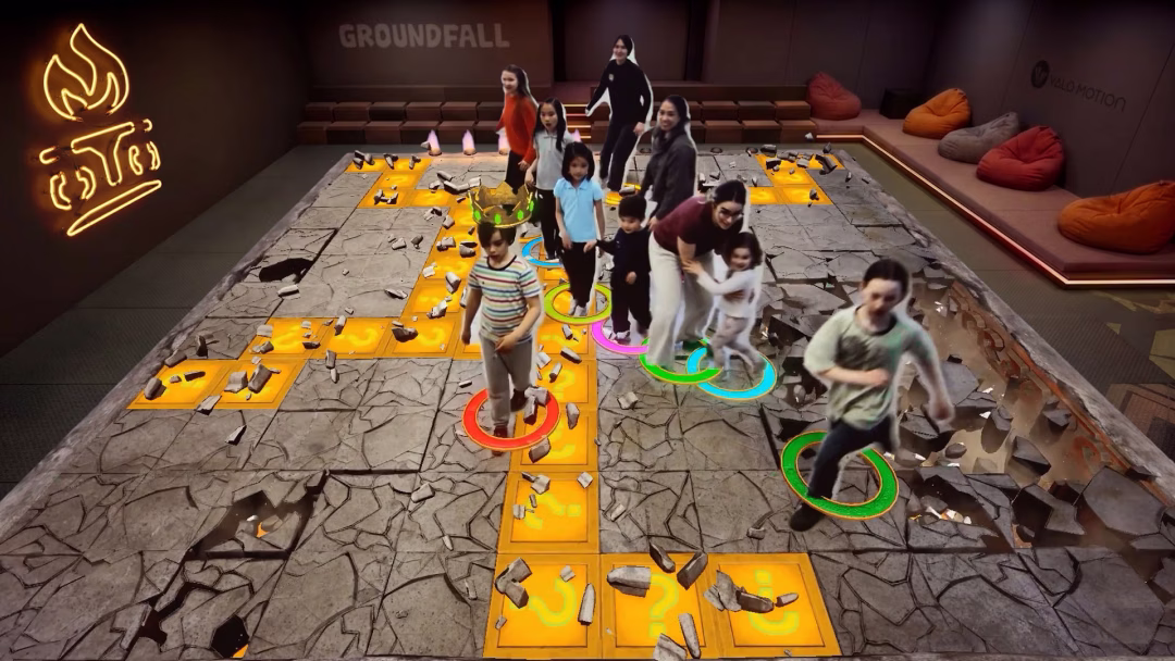 10 people enjoying a game of Groundfall. The group has kids aged 5+ and their moms playing together.