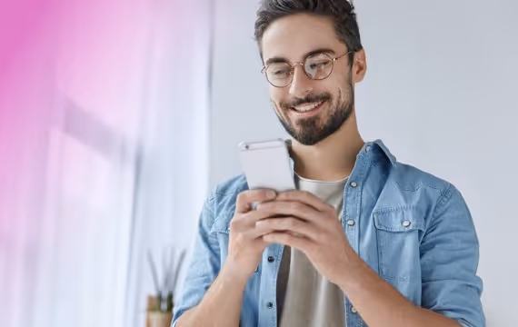 Man looks at his mobile and smiles