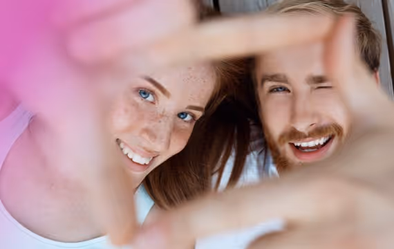 A young couple takes a funny selfie