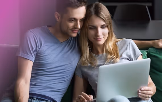 Young couple reads about infertility on PC