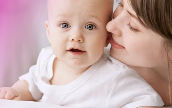 Young mother cuddles with her baby