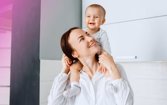 Kvinnelig fertilitetspasient med sin baby hjemme