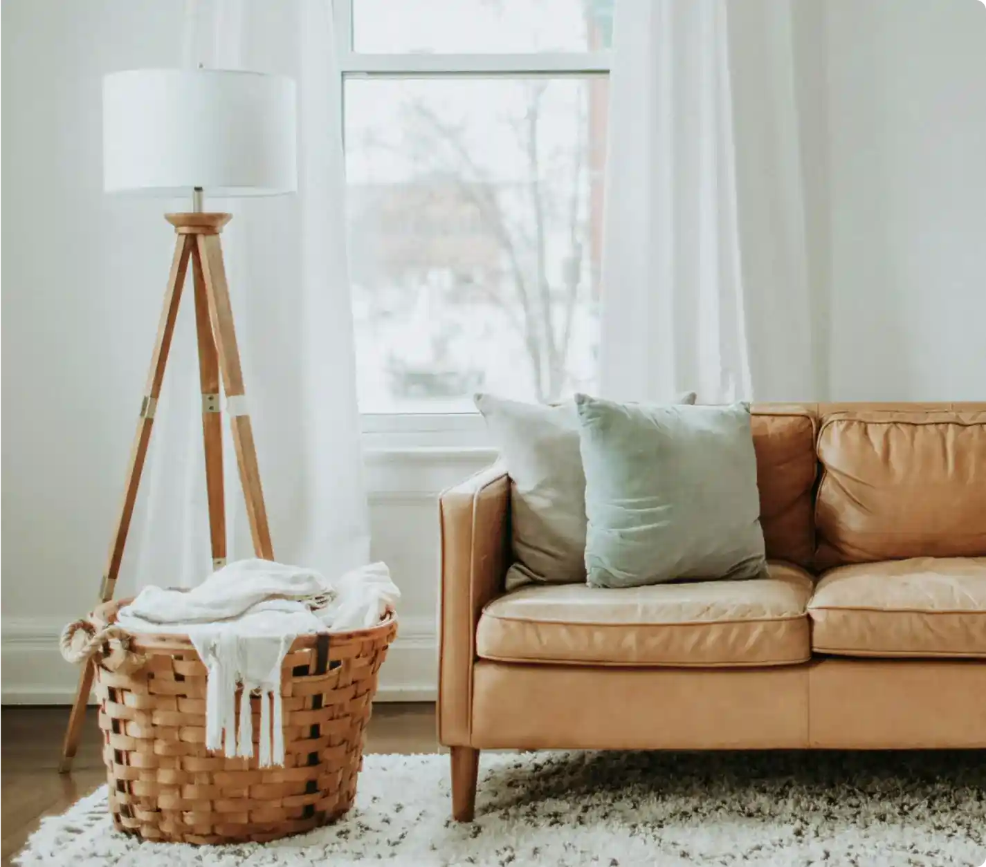Bright and cozy living room with soft furnishings, reflecting the value of Airbnb management services.