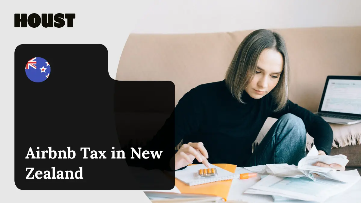 Woman on a sofa using a calculator beside receipts, a notebook and a laptop, featured image for Houst's guide to Airbnb tax in New Zealand