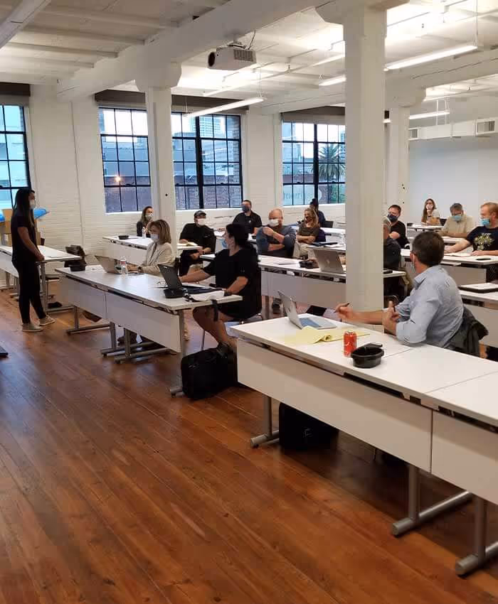 classroom full of people looking at laptops