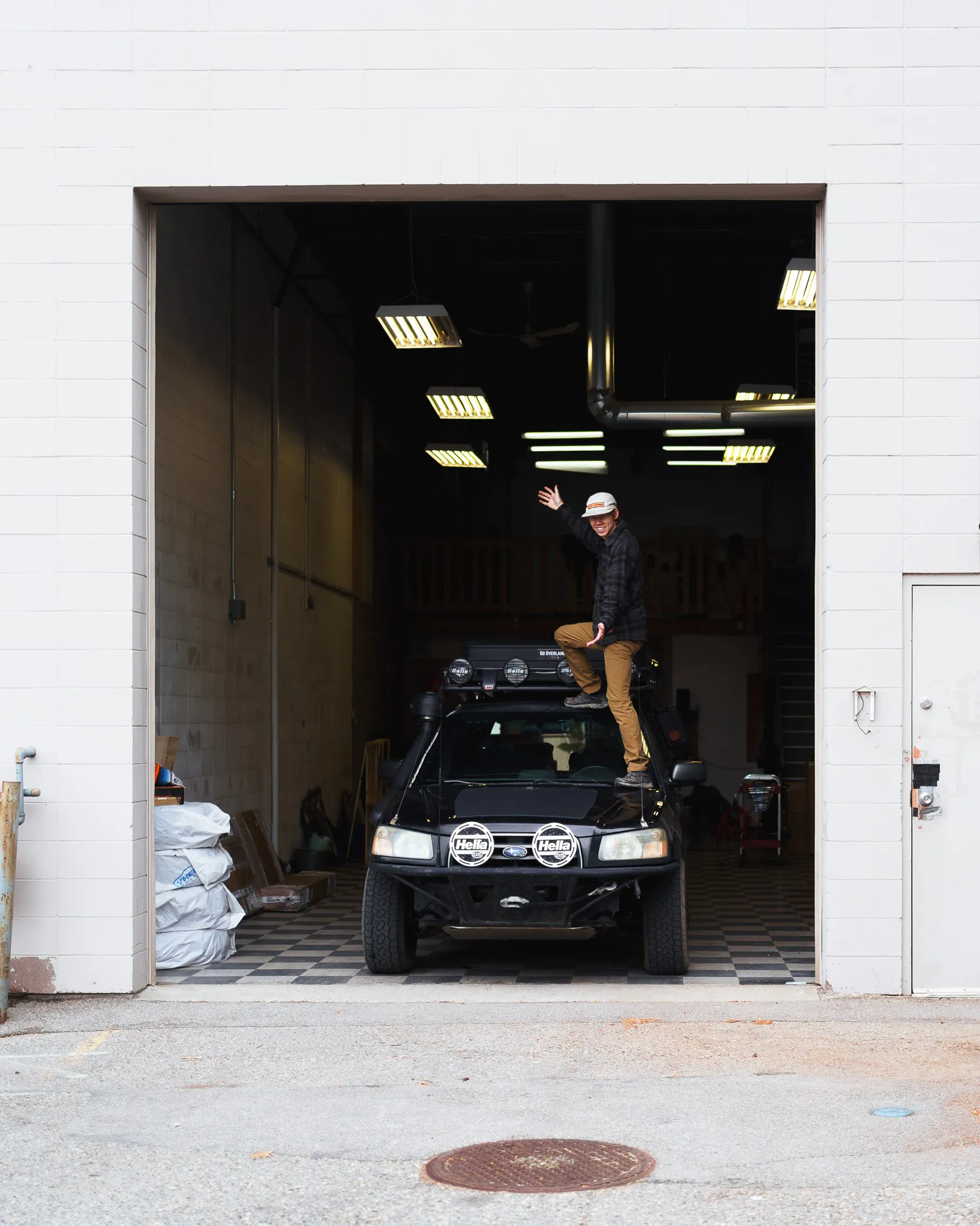 Chase Schrader with his lifted Subaru Forester opening the roof top tent