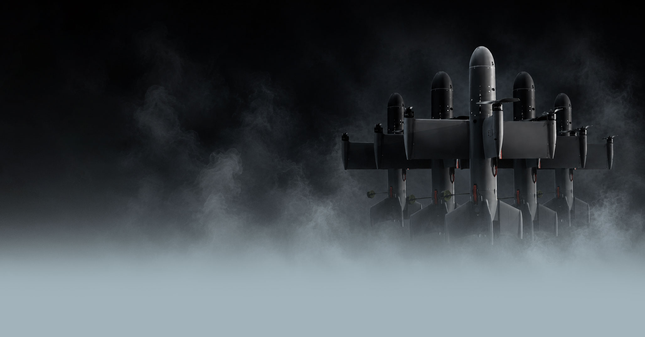 Five dark interceptor drones in fog against a black background, aligned side by side.