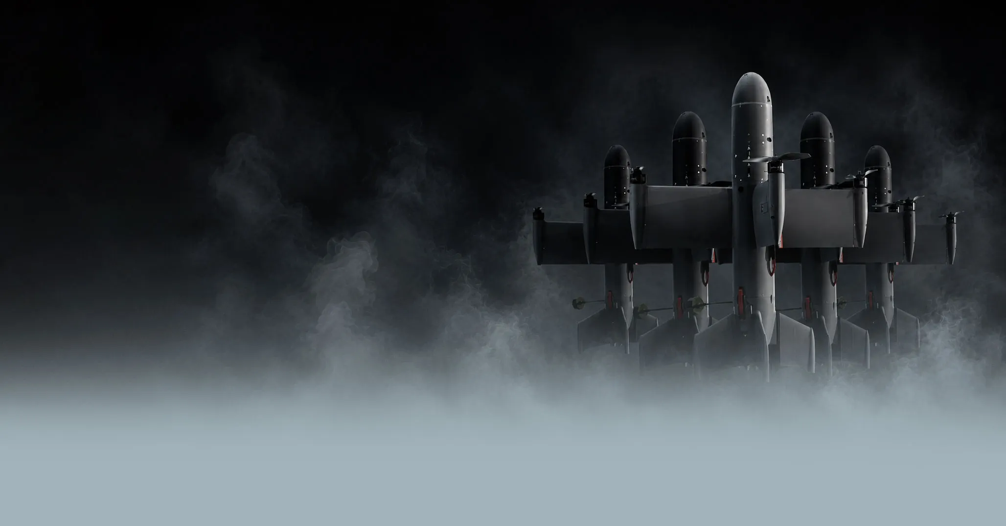 Five dark interceptor drones in fog against a black background, aligned side by side.