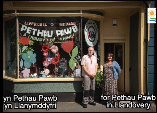 Photo of Helen and Rhys front of shop building