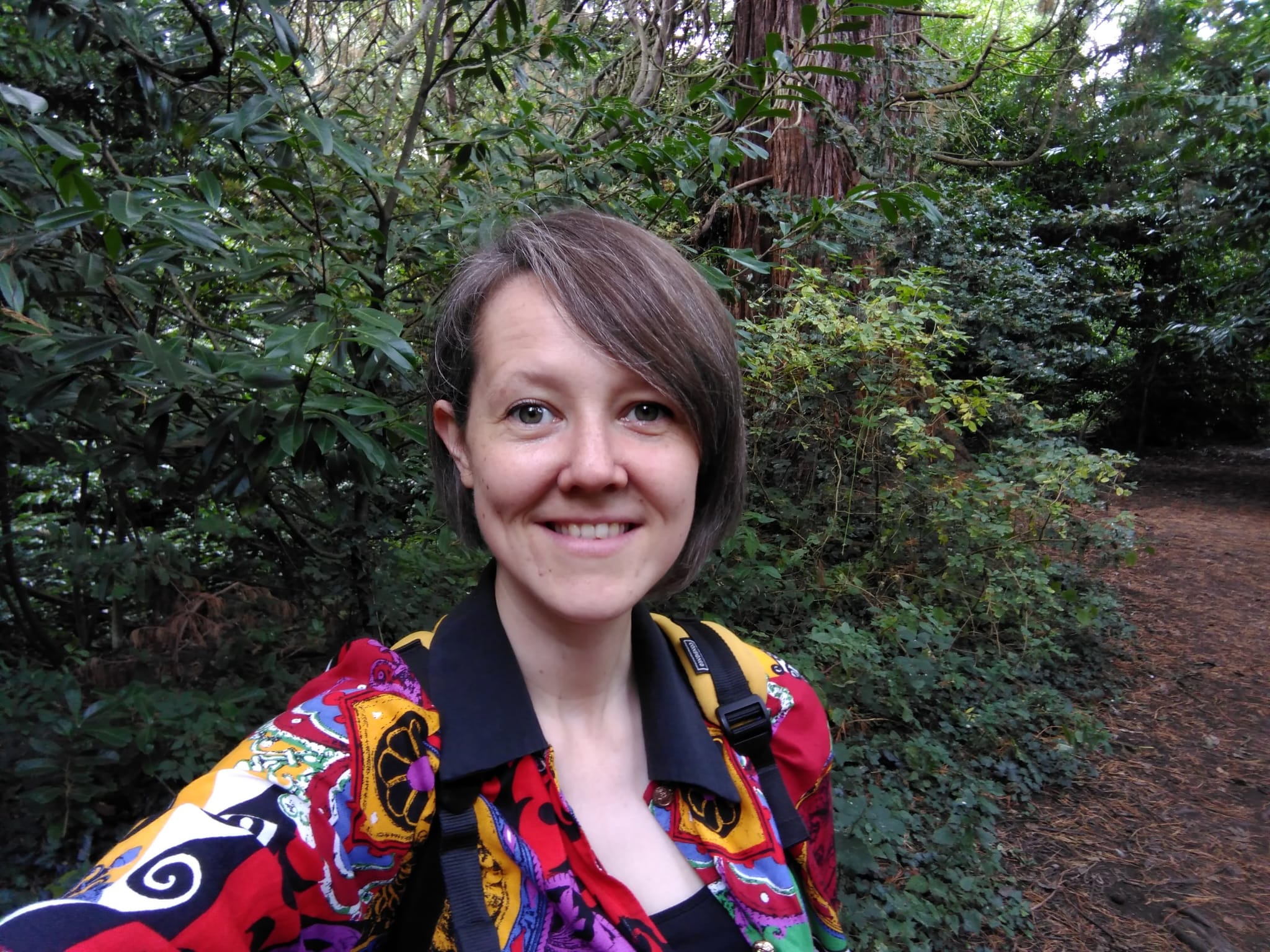 Lowri Jenkins looks at camera in a wooded area