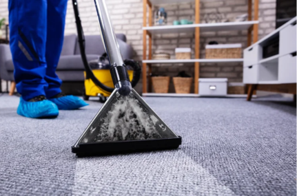 Close up of a machine cleaning a carpet in a living room