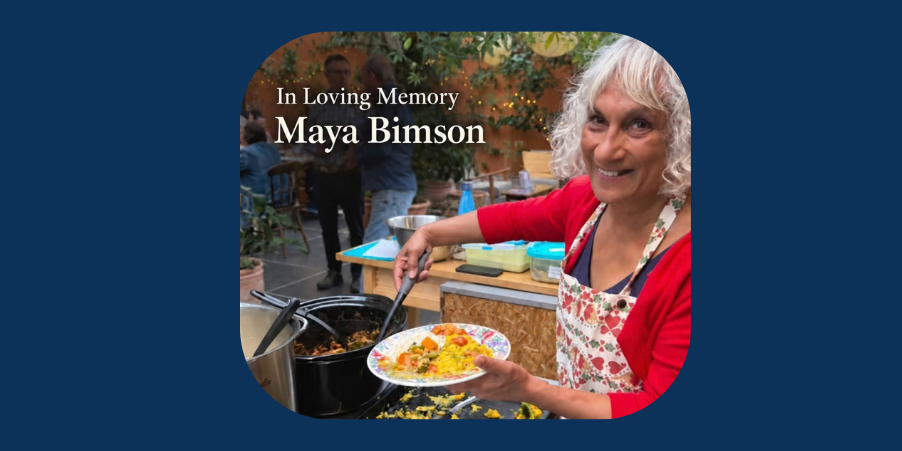 A photo of Maya smiling at the camera, while filling a bowl with food.