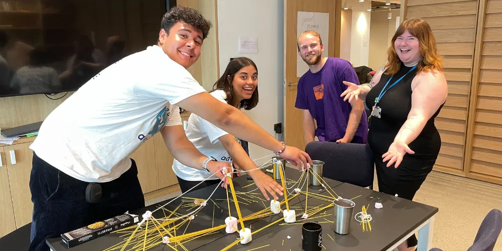 Team building with staff, including a competition building a spaghetti and marshmallow bridge