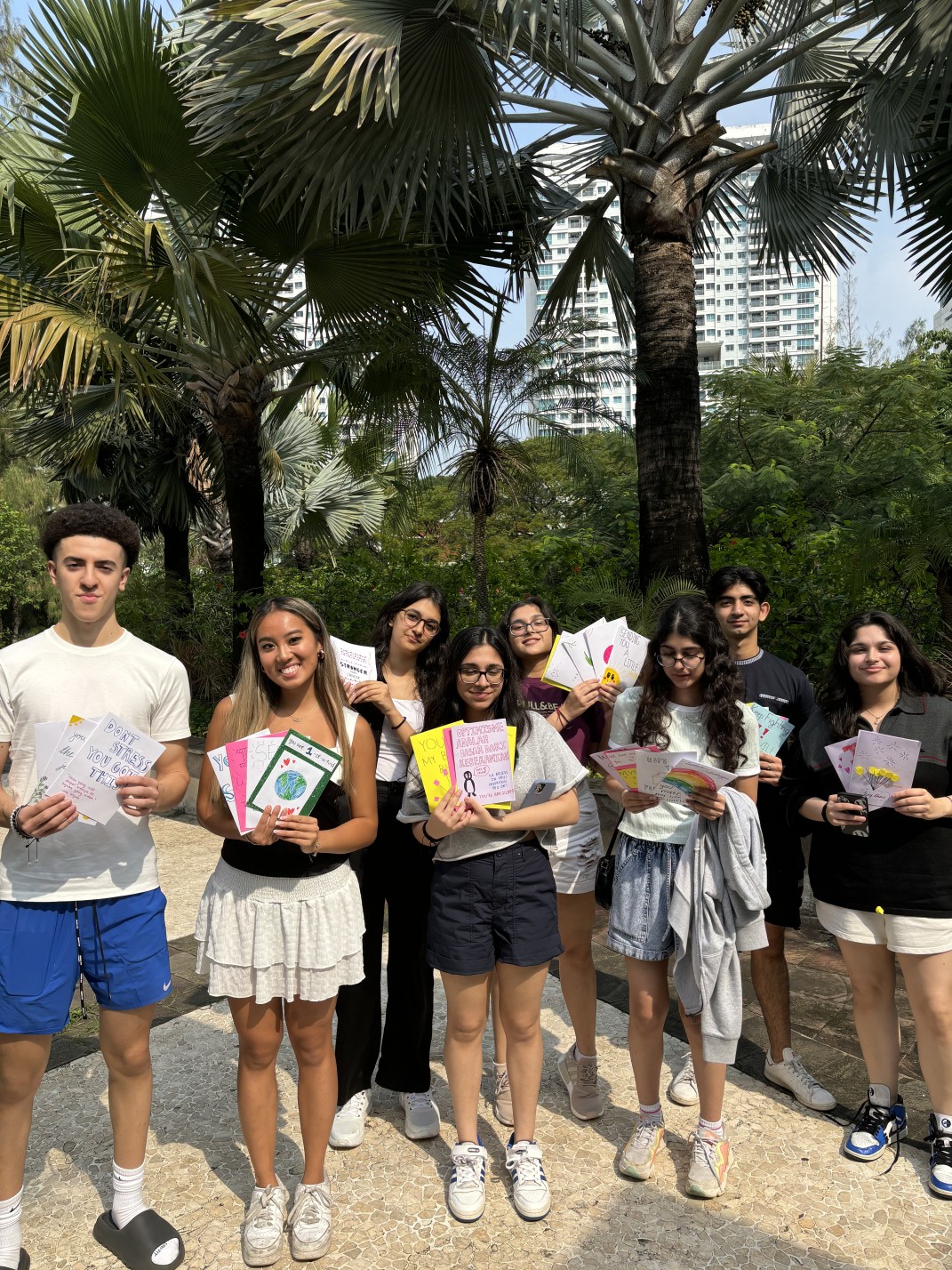 Olivia and the Cancer Kids First team holding handmade cards of encouragement