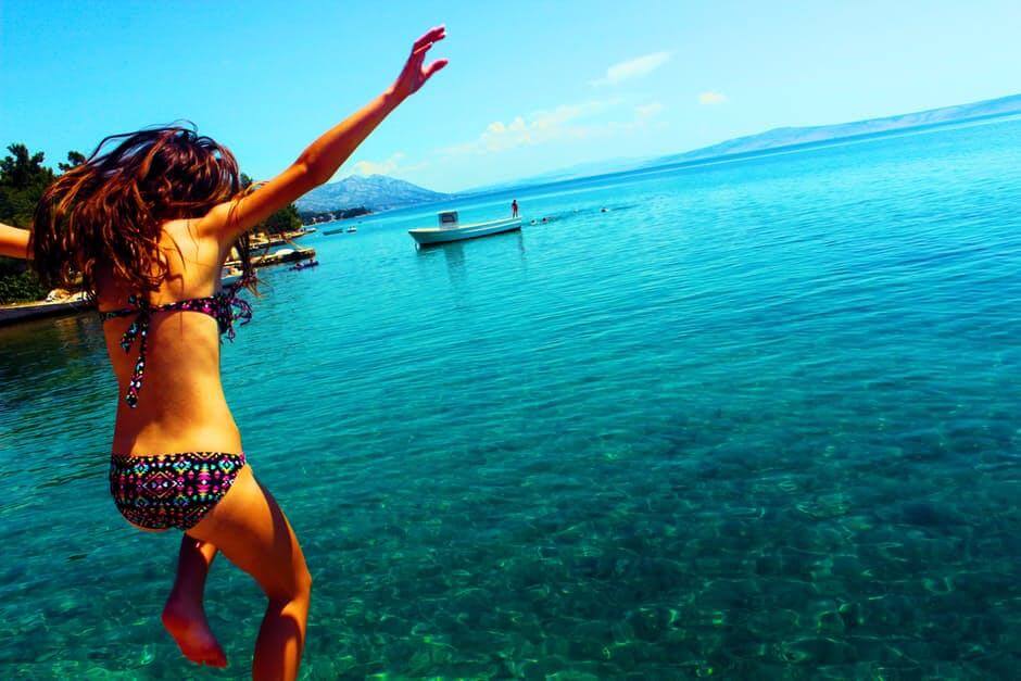 A women jumping into the ocean