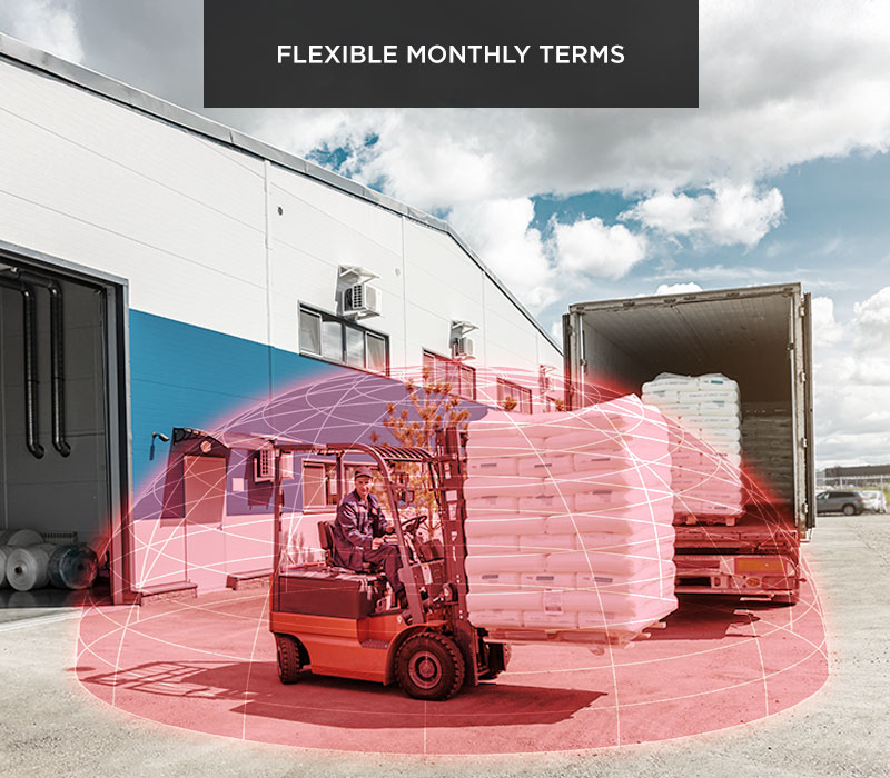 A forklift carrying a load outside a warehouse with a SensorZone detection bubble superimposed around it.