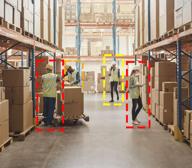 Four workers down a warehouse aisle, all working and surrounded by SensorZone detection boxes.