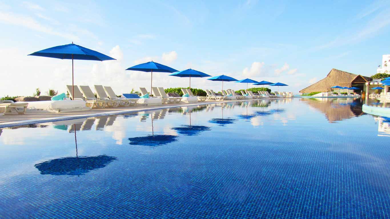 Infinity pool with blue umbrellas