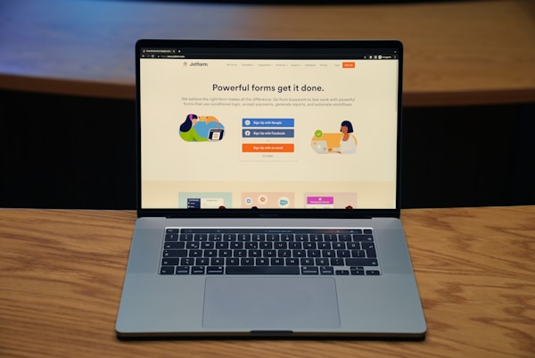 Photo of a Macbook laptop showing a screenshot from Jotform website