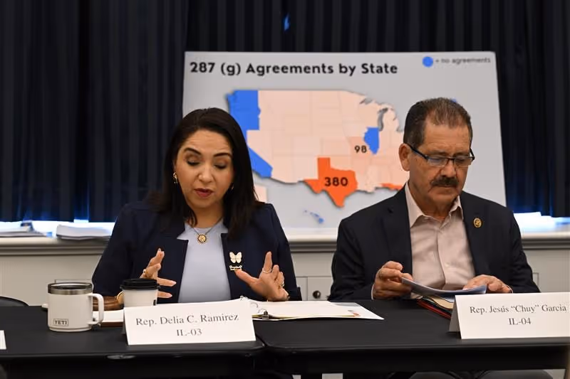 Photo of U.S. Representatives Delia Ramirez (IL) and Chuy Garcia (IL) at a Congressional shadow hearing on ICE's 287(g) program, with a poster board behind them titled "287(g) agreements by state"