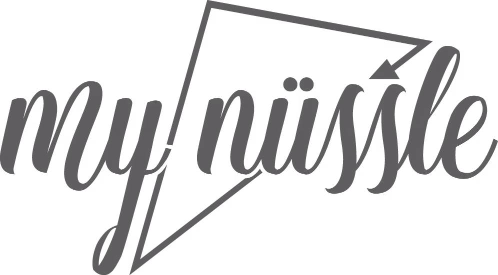 Logo with a stylized script reading 'my nüssle' inside an angular outline with an arrow.