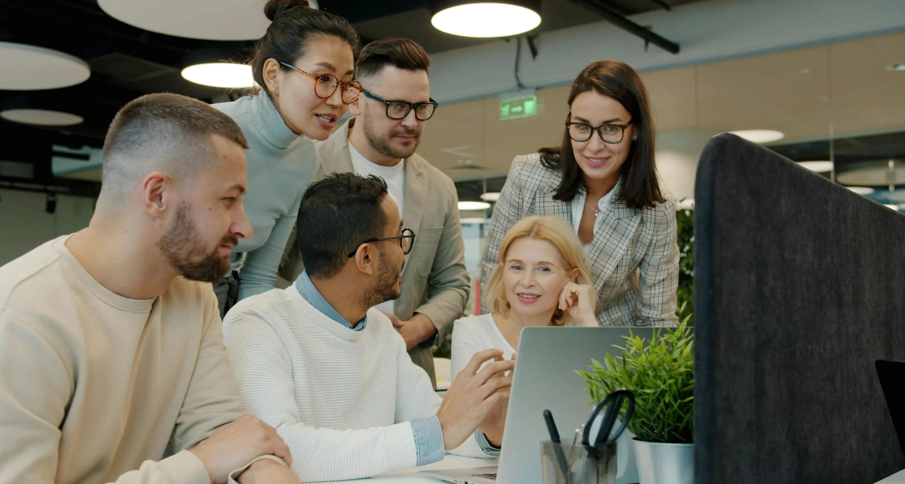 Team bespreekt samen de resultaten op een laptop op kantoor