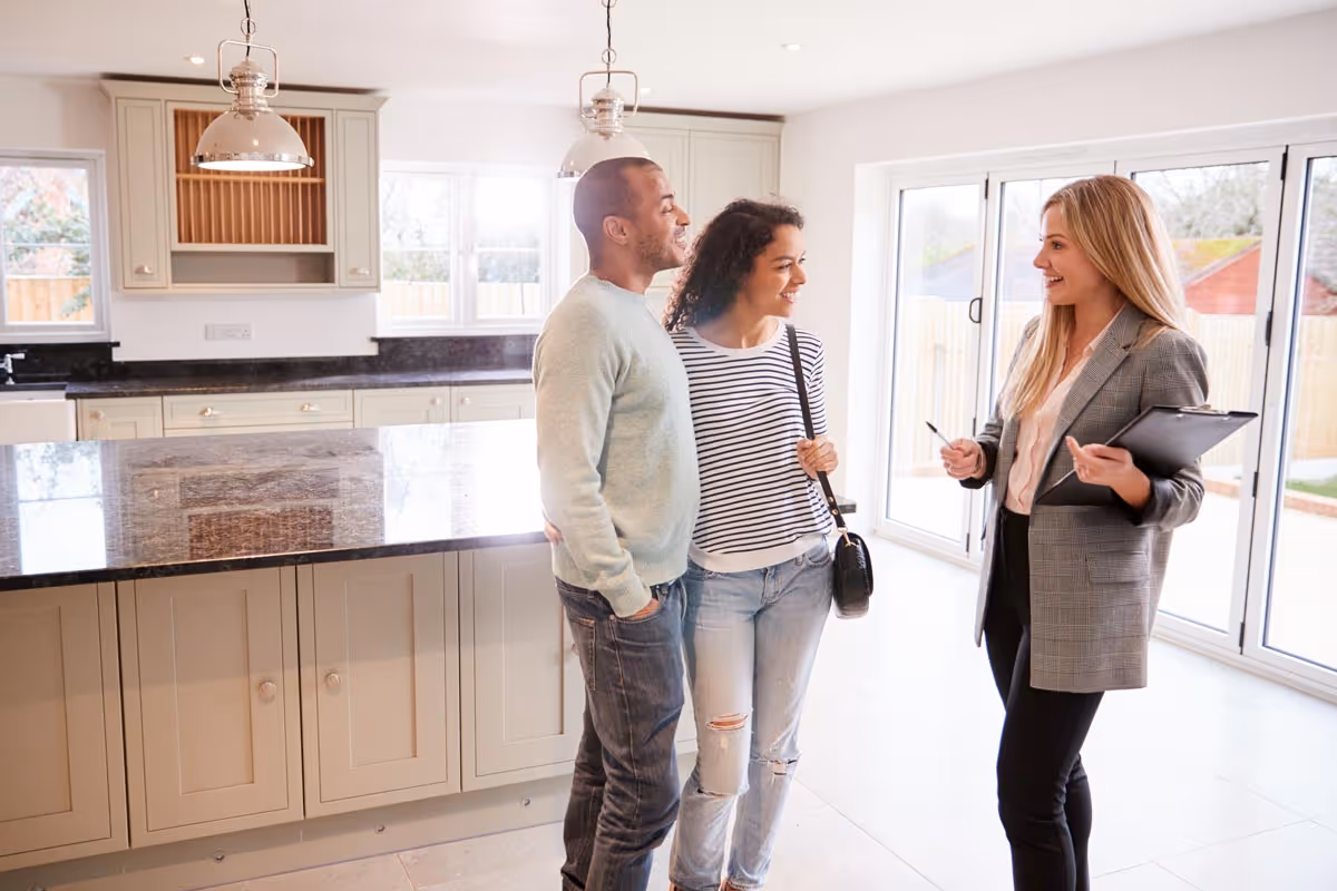 Realtor showing home to young couple