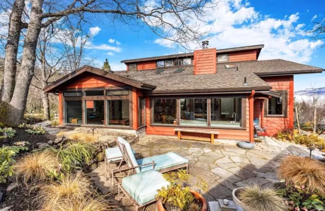 Red home with large windows and attic dormer