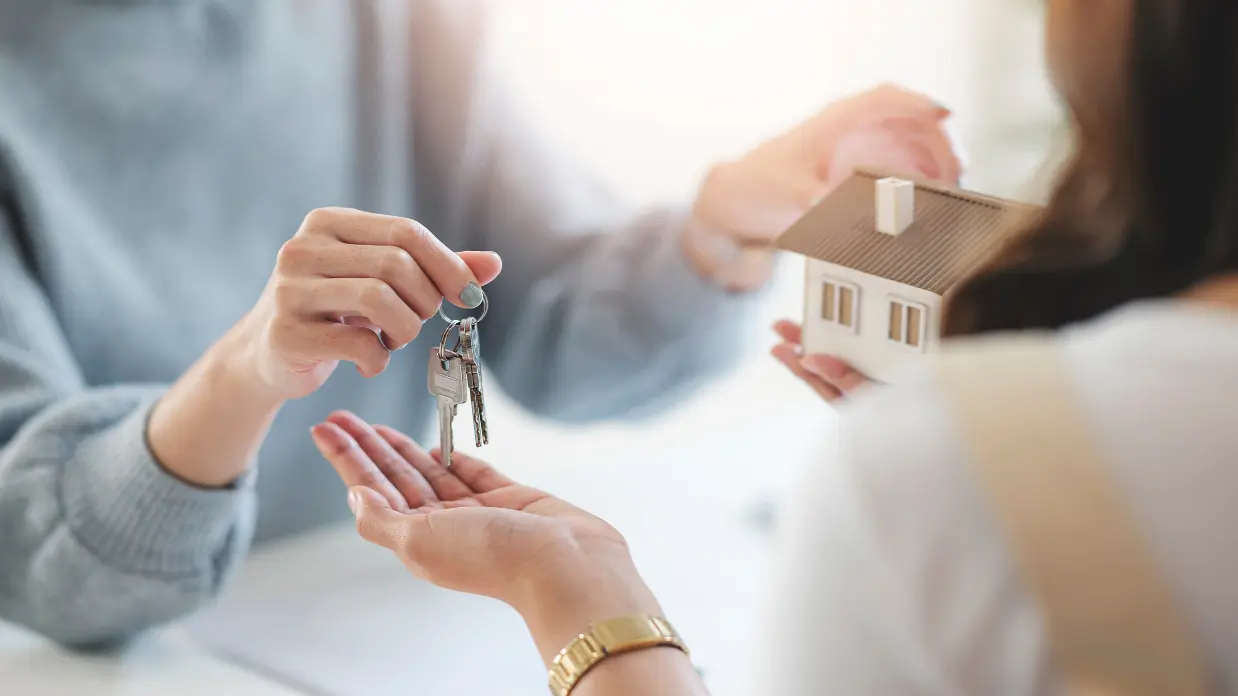 Realtor handing a new homeowner house keys