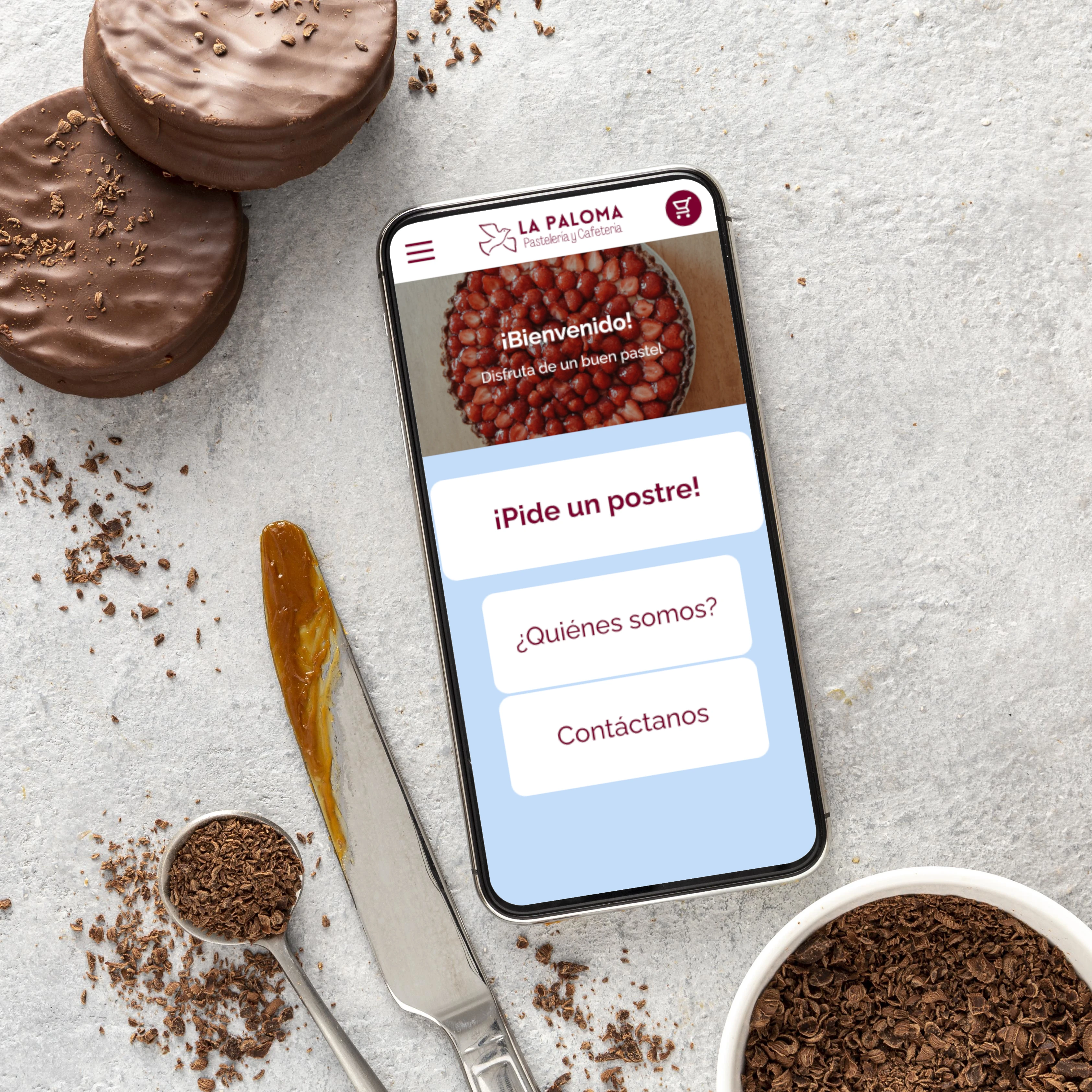 Aplicación móvil de la pastelería La Paloma aplicada a un teléfono móvil.