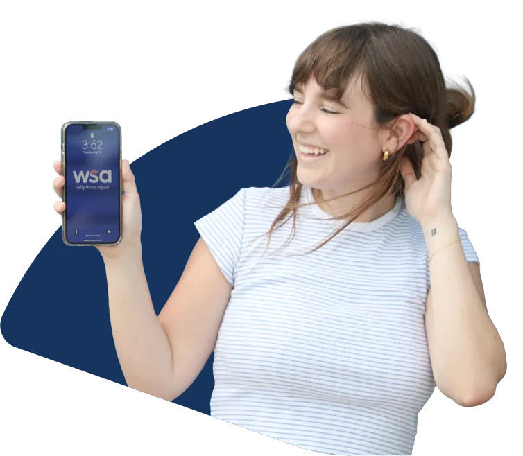 A girl holding up her phone displaying the wsa logo on the screen