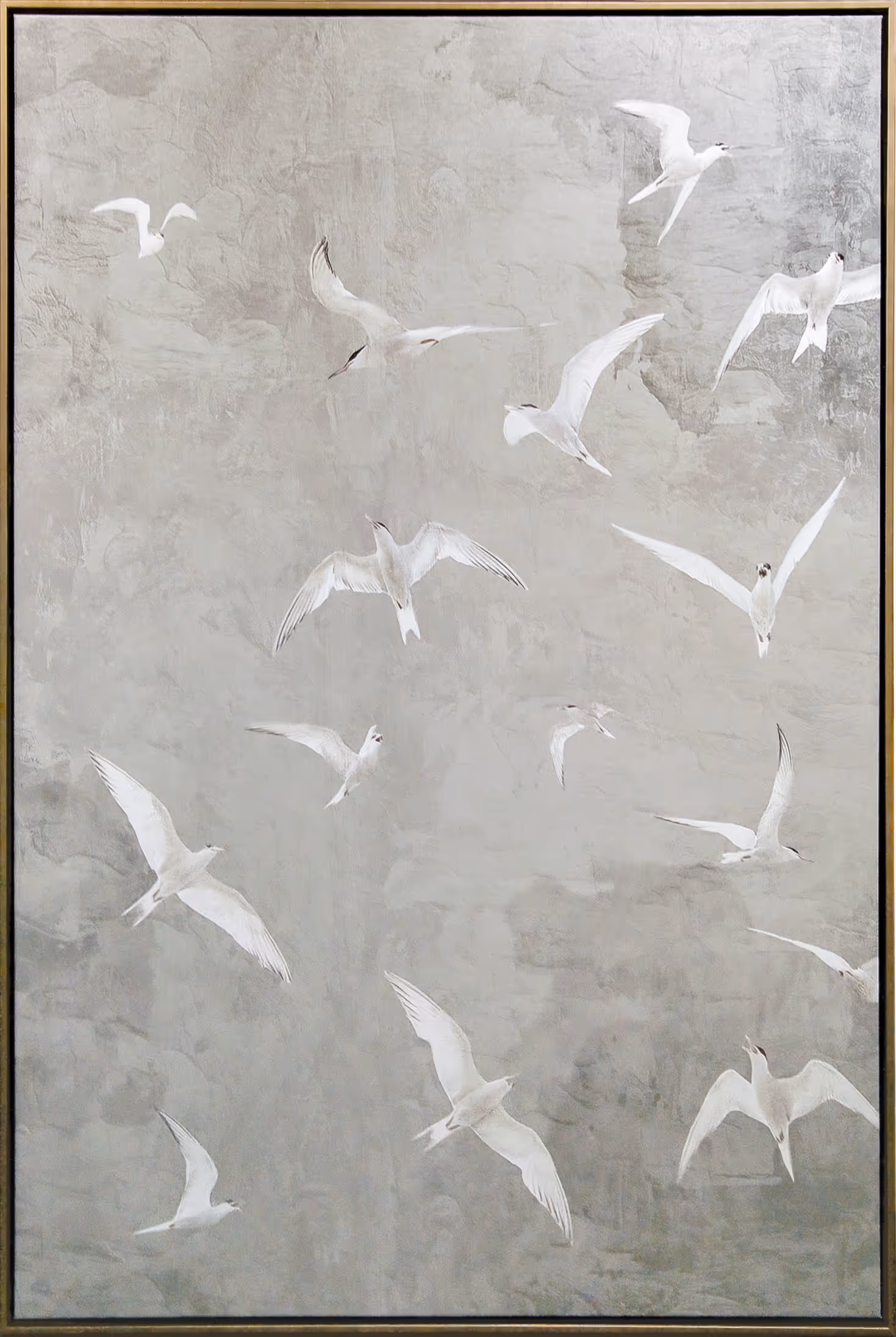 Soft tones of mist gray, pale stone, and muted ivory form a gently textured background against which luminous white birds sweep across the composition in varied, graceful motion. The vertical arrangement emphasizes upward movement and openness, while the clean frame presentation gives the piece a refined, contemporary presence suited to calm, light-filled interiors.