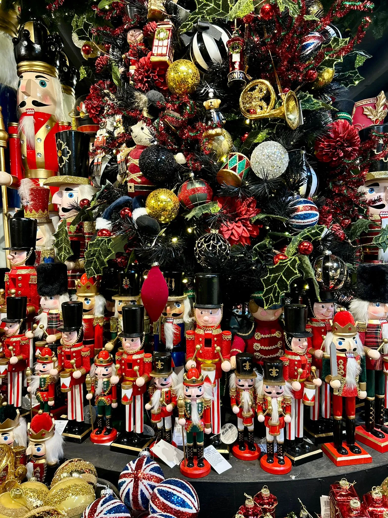 Decorated Christmas tree surrounded by rows of nutcracker soldier ornaments in the shop