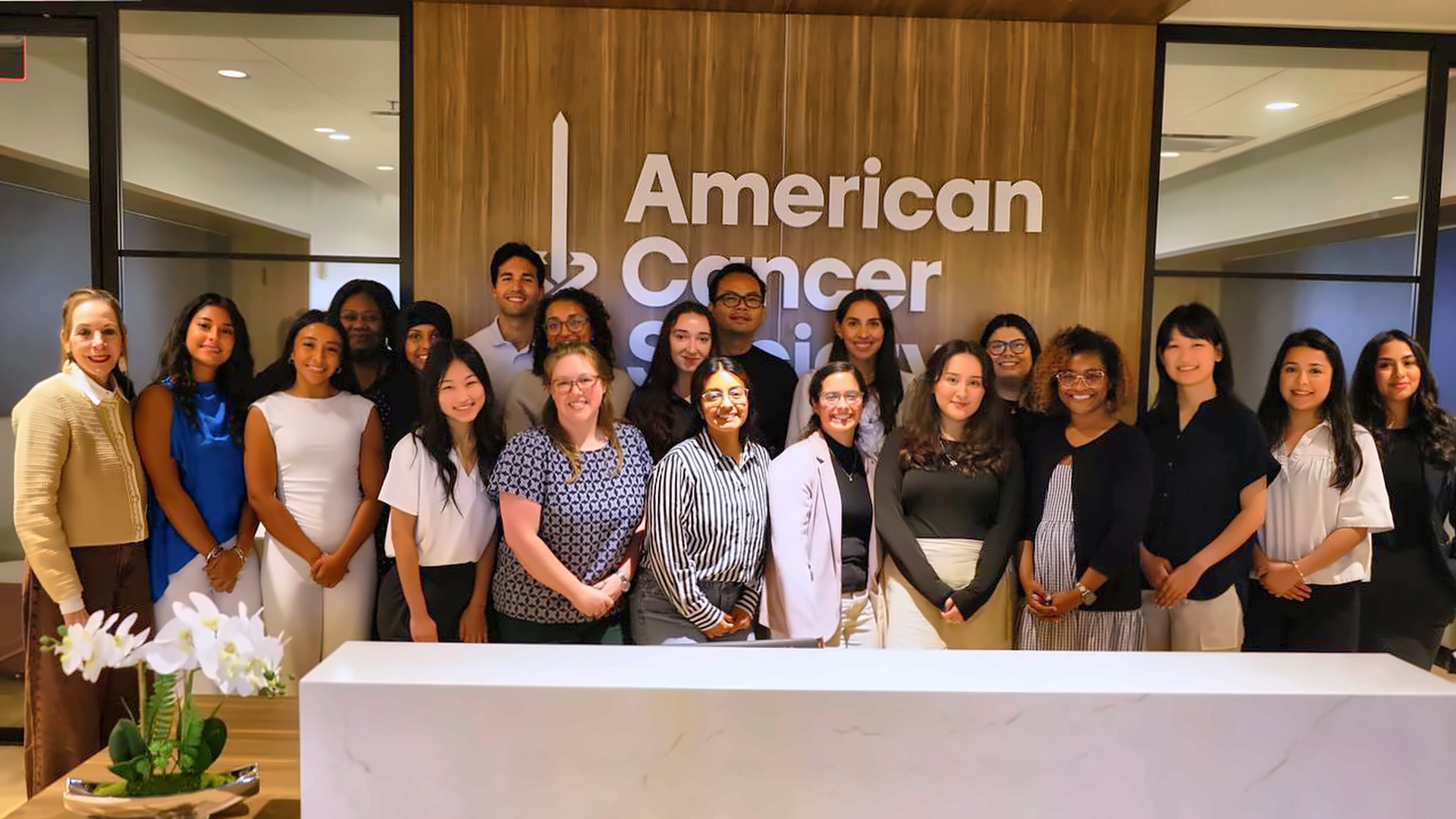 Medical, nursing, and public health students and HHCGA staff stand together in front of the American Cancer Society sign in Atlanta after ambassador certification.
