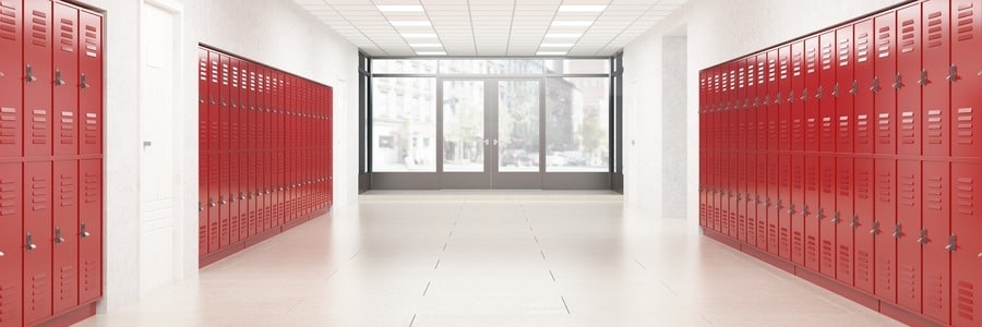 Empty school hallway with red lockers.